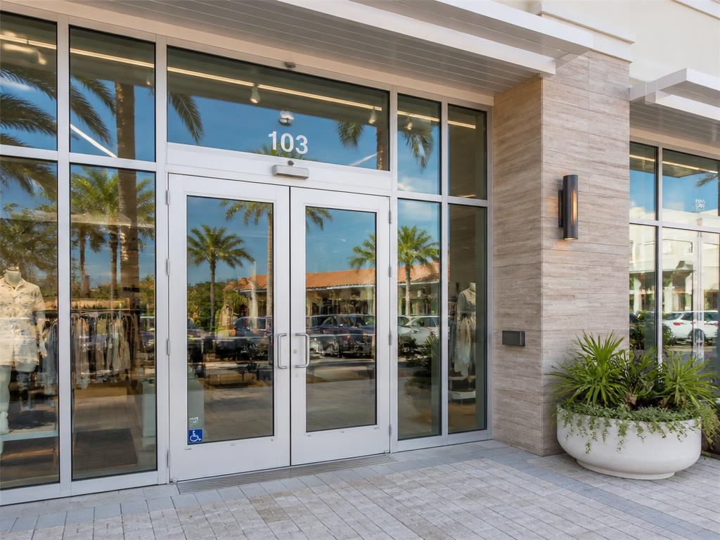 Modern Florida retail storefront with aluminum glass entrance doors, panic hardware, and ADA-compliant threshold.