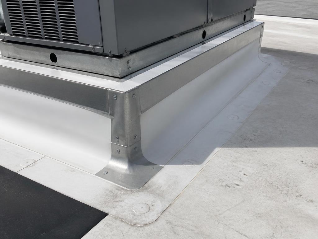 Commercial HVAC curb on a flat TPO roof in Sarasota County, surrounded by raised metal counter-flashing and sealed membrane seams.